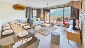 a living room with a table and a dining room at Les 360 - Apt 15 - BO Immobilier in Châtel