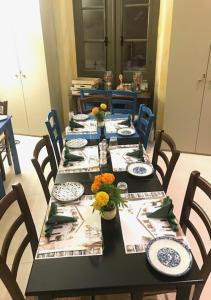 a dining room table with blue and white plates and chairs at Casa Mespilea in Paphos