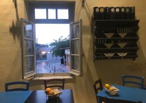 a room with two tables and a window at Casa Mespilea in Paphos