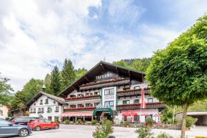 a hotel with cars parked in front of it at Hotel & Gasthof Taferne in Schladming