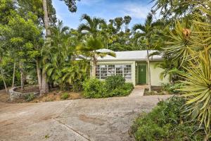 a house with a green door and palm trees at Bright St Thomas Getaway with Pool, 3Mi to Magens Bay in Mafolie