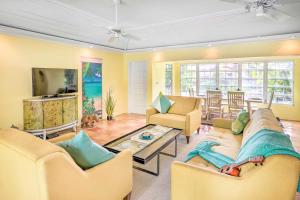 a living room with two couches and a tv at Bright St Thomas Getaway with Pool, 3Mi to Magens Bay in Mafolie