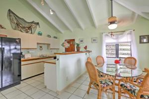 a kitchen with a table and chairs and a window at Breezy St Croix Bungalow with Pool and Ocean Views! in Christiansted