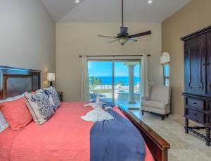a bedroom with a bed with a view of the ocean at Cabo Hacienda with Private Pool and Rooftop Terrace! in Cabo San Lucas