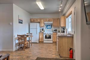 a kitchen with white appliances and a table and chairs at Homer Hideaway on Fritz Creekside - Pets Welcome in Homer
