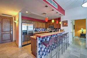 a kitchen with a bar with stools in it at Paraiso del Mar Resort Condo Water Taxi to La Paz in La Paz