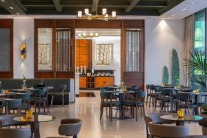 a dining room with tables and chairs at Aliathon Ionian in Paphos City