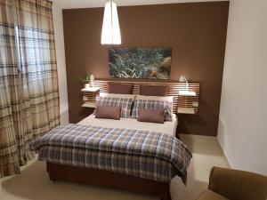 a bedroom with a bed and a lamp at Mondello Suites Feels Like Home in Mondello