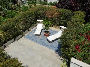 an overhead view of a patio with two benches at Mondello Suites Feels Like Home in Mondello