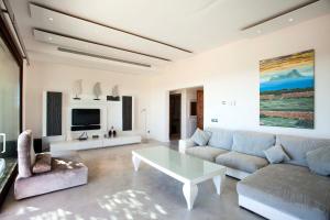 a living room with a couch and a coffee table at Casa Romero in Cala Saona