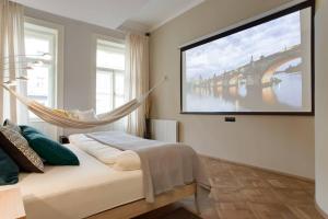 a bedroom with a bed and a hanging hammock at BRIGHT Prague Na Poříčí in Prague