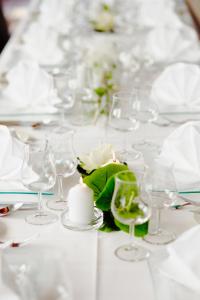 a table with wine glasses and a candle on it at Hotel Klinkner in Emmelshausen