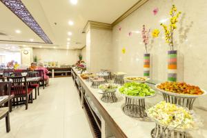 a buffet line with bowls of food in a restaurant at Paris Luxury Hotel & Apartment Nha Trang in Nha Trang