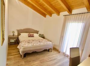 Ένα ή περισσότερα κρεβάτια σε δωμάτιο στο Agriturismo Casale ai Prati