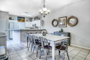 a kitchen and dining room with a white table and chairs at Beach Pointe in Destin