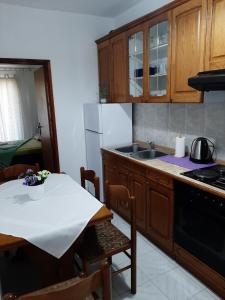 a kitchen with wooden cabinets and a white counter top at Apartments Ana in Podstrana