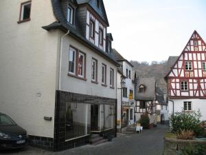 a street in a small town with buildings at Moselhaus Tante Emma in Pünderich