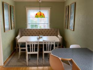 a dining room with a table and chairs and a window at 5-Bedroom House in Lofoten in Ramberg