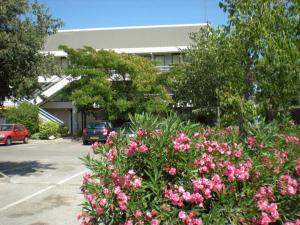 a bush of pink flowers in front of a building at Premiere Classe Toulon La Seyne-sur-Mer in La Seyne-sur-Mer