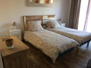 a bedroom with two beds and a table at La belle histoire Gîte Montmirail in Bédoin +43 photos