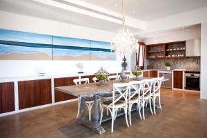 a kitchen with a dining room table and chairs at Casa Santolina in Cala Saona