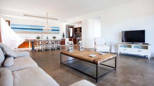 a living room with a couch and a coffee table at Casa Santolina in Cala Saona