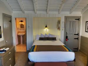 a bedroom with a large bed and a bathroom at Bright Angel Lodge - Inside the Park in Grand Canyon Village