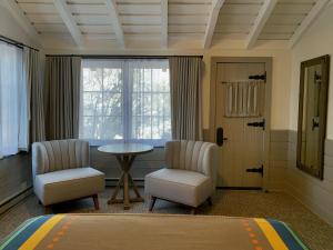 a room with two chairs and a table and a window at Bright Angel Lodge - Inside the Park in Grand Canyon Village