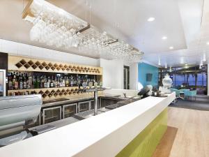 a kitchen with a bar with wine bottles at Hedland Hotel in Port Hedland