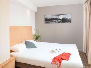 Aparthotel Adagio Toulouse Centre Ramblas客房内的一张或多张床位