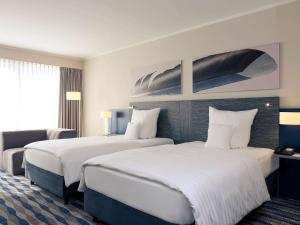 Ein Bett oder Betten in einem Zimmer der Unterkunft Mercure Hotel am Entenfang Hannover