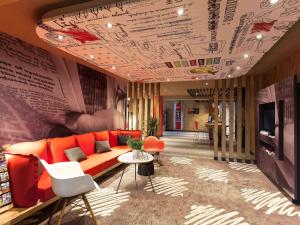 a living room with a couch and a table at ibis Cherbourg La Glacerie in Cherbourg en Cotentin