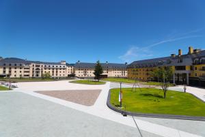 a large building with a courtyard in front of it at Lotte Arai Resort in Myoko
