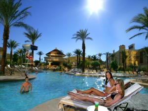 three women sitting in the pool at a resort at South Point Hotel Casino-Spa in Las Vegas