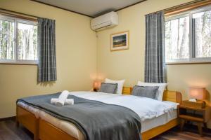 מיטה או מיטות בחדר ב-Villa 777 Hakuba