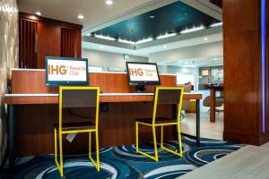 Holiday Inn Express & Suites Orlando- Lake Buena Vista, an IHG Hotel في أورلاندو: مكتب ريفي مع كرسيين في مكتب