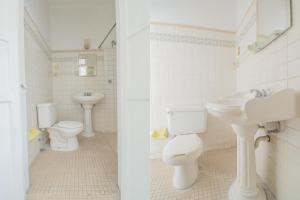 a bathroom with two toilets and a sink at Hotel Imperial in Aguascalientes