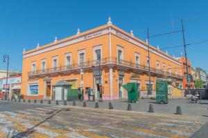 an orange building on the corner of a street at Hotel Imperial in Aguascalientes