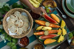 a table with a plate of vegetables and bread at Kulu Safaris - All Inclusive in Yala