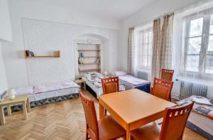 a living room with a table and a dining room at Rodinný hostel Stárkův dům in Tábor