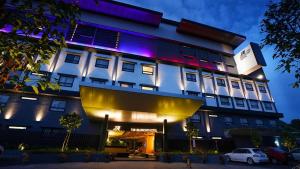 a lit up building with a car parked in front of it at TSR Seafront Hotel in Port Dickson