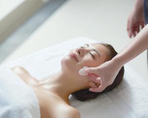 a woman in a bathtub getting her face washed at Nippondaira Hotel in Shizuoka