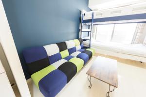 a room with a couch and a table at COCOSTAY月光千日前3F - Cocostay Gekkou Sennichimae3F in Okayama