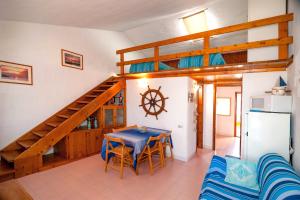 a living room with a table and a staircase at CASA del CAPITANO in Porto Ottiolu +20 photos