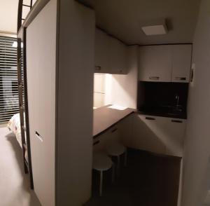a small kitchen with white cabinets and a counter at Guest House Località Sorbara in Asola