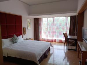 Letto o letti in una camera di Dongguan Well Garden Hotel