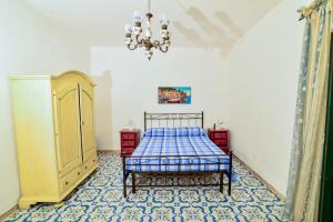 Schlafzimmer mit einem Bett und einem Kronleuchter in der Unterkunft SoleMarePonza casa Antonietta in Ponza