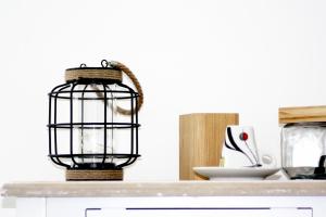 a bird cage on top of a kitchen counter at Logis Hôtel Sea View in Saint-Gilles-Croix-de-Vie