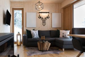 a living room with a couch and a table at Chalet Sunnseitn - auf der Turracher Höhe in Turracher Hohe