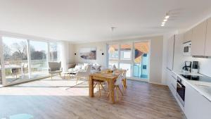 a kitchen and living room with a table and chairs at Beach'n'Sea Wohnung 5 in Grömitz